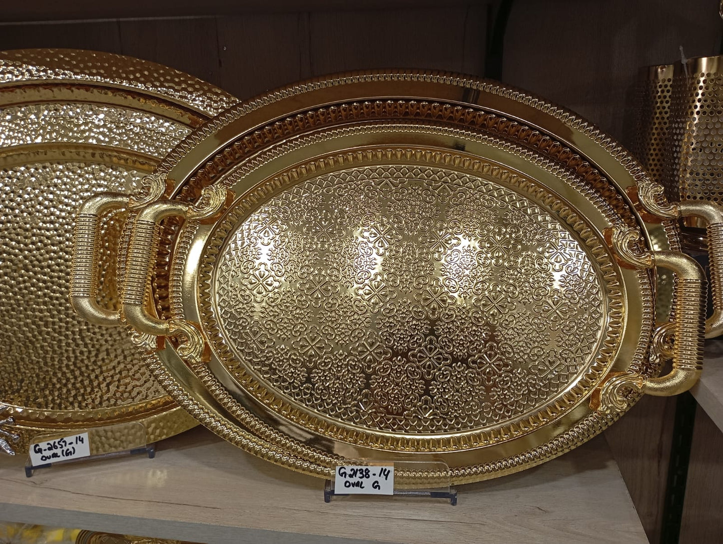 Turkish-style gold serving trays with intricate embossed or hammered textures and ornate handles