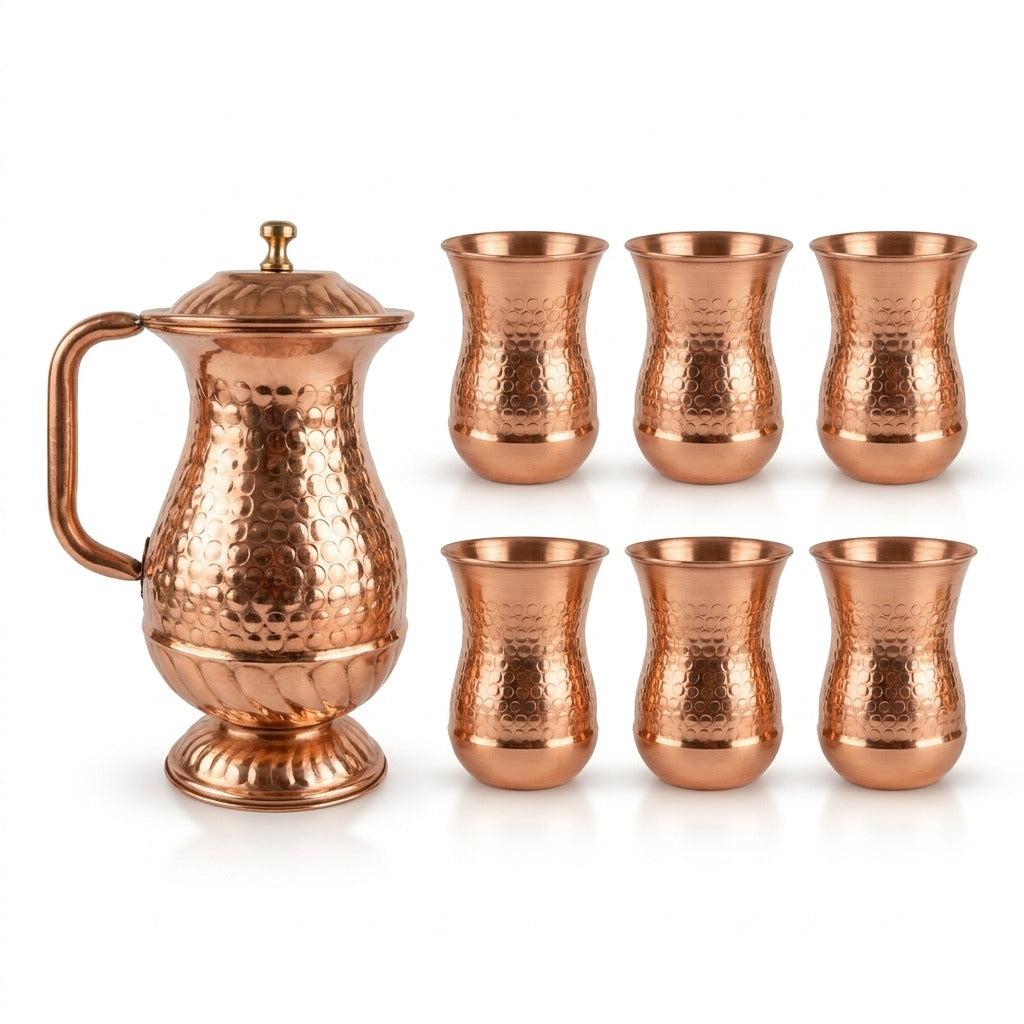 hammered pure copper water set that includes a lidded pitcher with a handle and six matching drinking glass