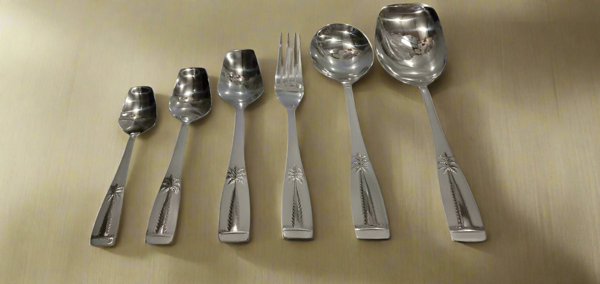 Stainless steel cutlery set with palm tree engraved handles, graduated spoons and fork