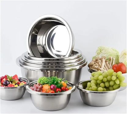 Steel mixing bowls filled with fruit and salad